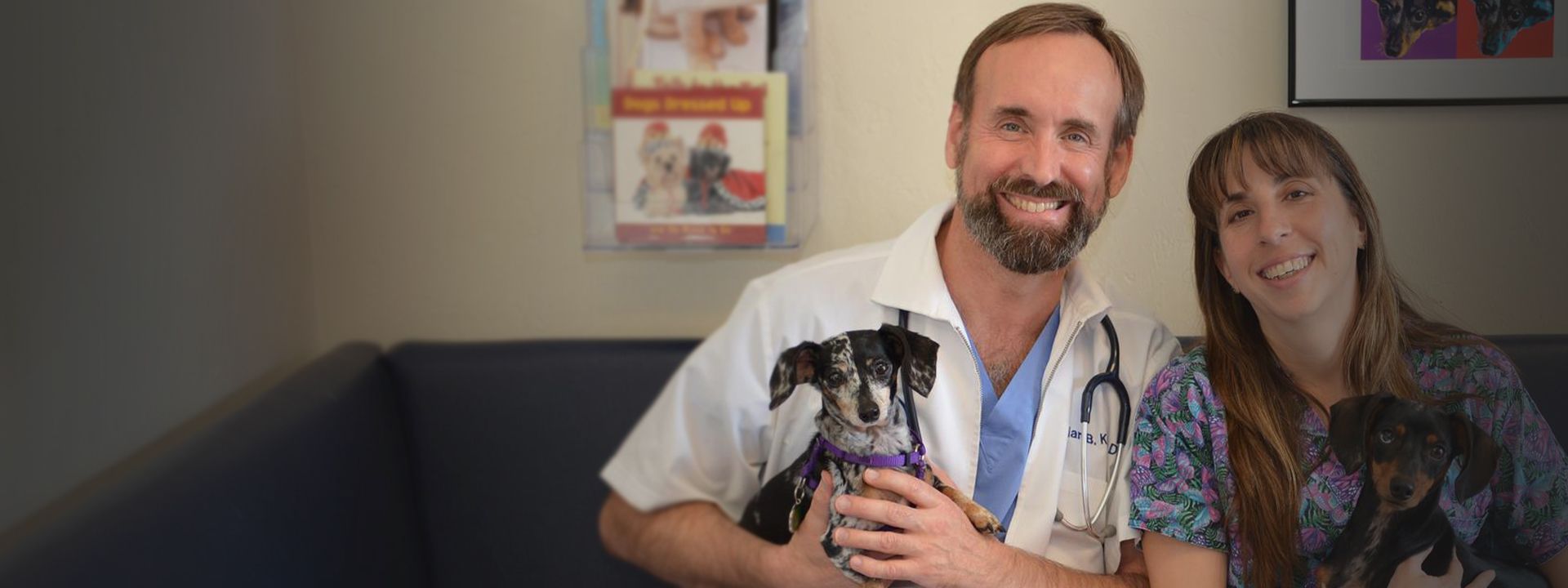 doctor ian kupkee with his dachshund dogs and a employee